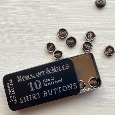 Shirt buttons in a tin
