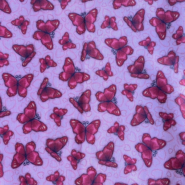 Tissu papillons rouges sur fond rose