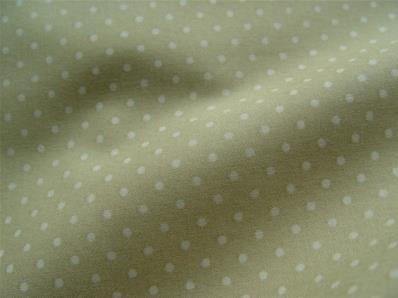 White dots on mustard yellow fabric